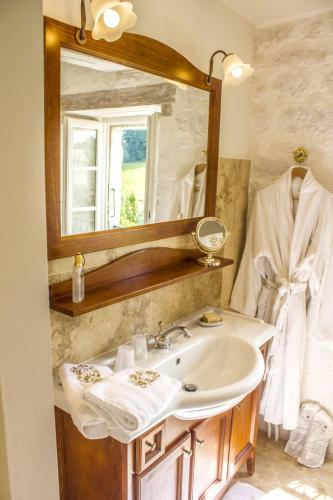 a bathroom with a sink and a mirror at Domaine de Saint-Géry - Teritoria in Lascabanes