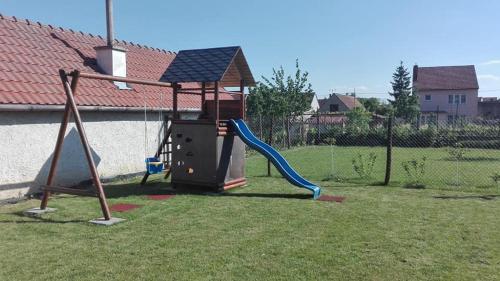 a playground with a slide in a yard at Penzion U Dvou lip in Drnholec