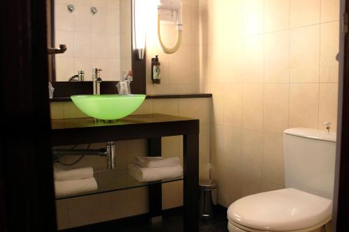 a bathroom with a green sink and a toilet at Castel Vecchio in Ajaccio