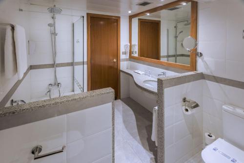 a bathroom with a sink and a mirror at GHT Oasis Park & Spa in Lloret de Mar