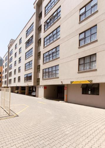 an empty parking lot in front of a building at Fedha Residences by Trianum in Nairobi