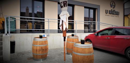 a group of barrels with an umbrella in front of a car at Penzion U Křížku in Kobylí