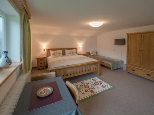 a bedroom with a bed and a living room at Landhaus Lilly in Obertraun