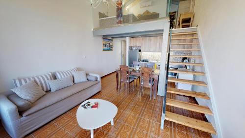 a living room with a couch and a table at Porto Enetiko Suites in Rethymno Town