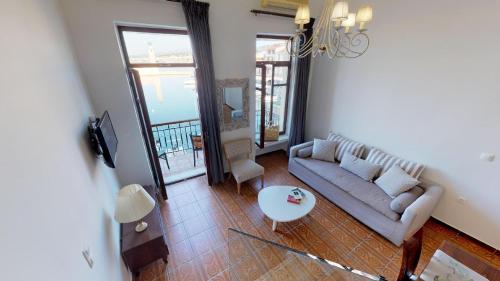 a living room with a couch and a table at Porto Enetiko Suites in Rethymno Town