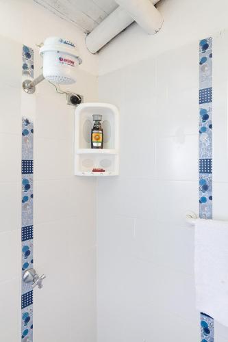 a bathroom with a shower with a soap dispenser at La Casa de Piedra in Guatapé