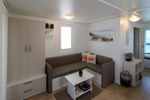 a living room with a couch and a table at Floating House Marina Royal in Portorož