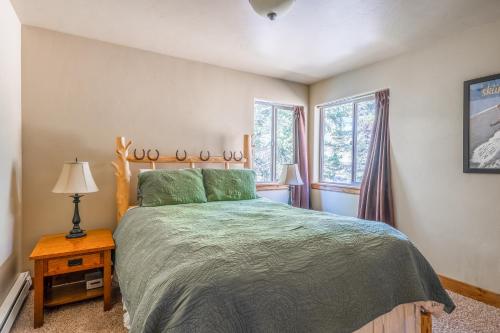 a bedroom with a bed and two windows at Gallatin River Getaway in Big Sky