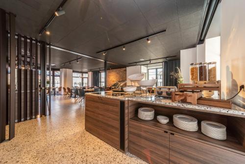 a kitchen with a counter with plates on it at Hotel Cajou in De Panne