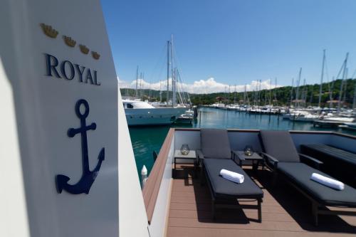 a row of chairs on the deck of a boat at Floating House Marina Royal in Portorož