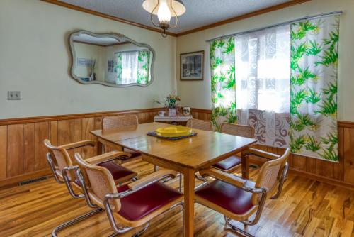 a dining room with a wooden table and chairs at Nautical North in Ocean City