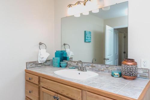 a bathroom with a sink and a large mirror at Rockport Getaway in Rockport
