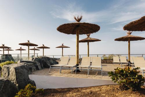 a group of chairs and umbrellas on the beach at Alua Village Fuerteventura - All Inclusive in Playa Jandia