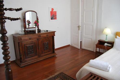 a bedroom with a bed and a mirror on a dresser at Hotel Miranda in Hydra