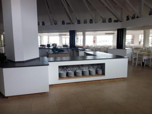 a kitchen with a counter with shoes on it at Club Esse Cala Bitta in Baja Sardinia