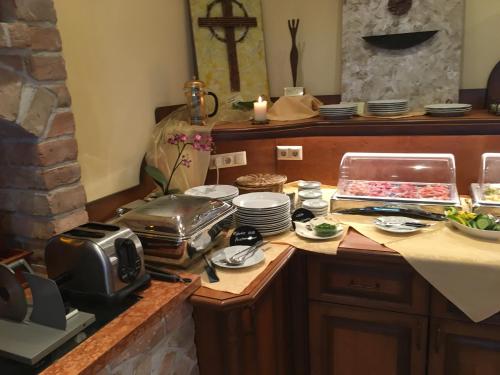 a kitchen with a counter with dishes and a microwave at Genießerhof Haimer - Hotel Garni in Poysdorf