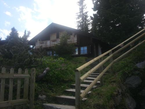a house on a hill with a staircase leading to it at Ferienhütte Rist in Kaltenbach