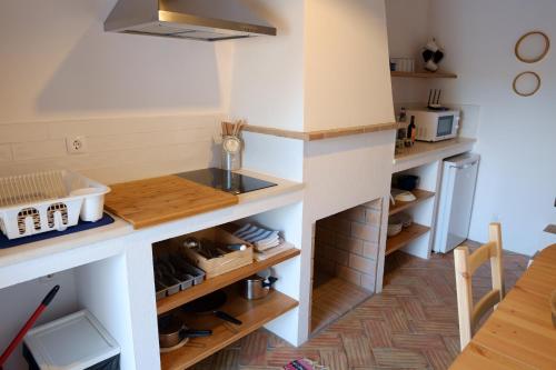 a kitchen with a counter and some shelves at Casas de Mértola in Mértola