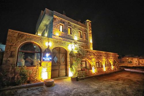 a stone building with lights on it at night at Katapa Stone House in Goreme