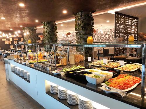 a buffet line with many different types of food at AP Maria Nova Lounge - Adults Friendly in Tavira