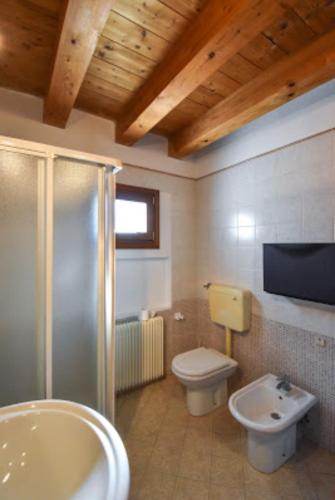 a bathroom with a shower and a toilet and a sink at Casamarin1 in Caorle