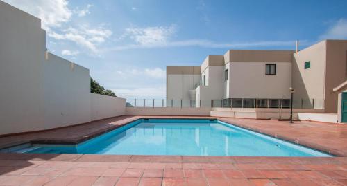 a swimming pool on the roof of a house at GuestReady - OceanView TopFloor w Terrace in Ponta Delgada