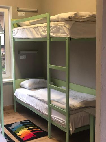 a bunk bed with two bunk beds in a room at Gala Hotel in Kamianets-Podilskyi