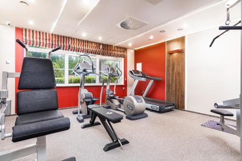 a gym with treadmills and exercise equipment in a room at Willa Kłodzko-Zacisze - sauna, siłownia, komnata solna, parking in Kłodzko