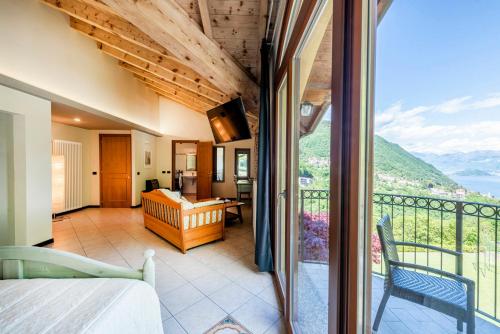 a bedroom with a balcony with a view of the mountains at Locanda Sant' Anna in Argegno