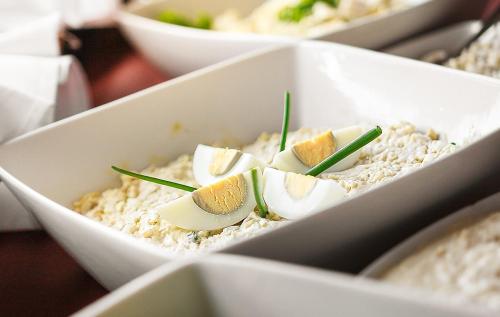 a white container filled with rice with eggs on top at Willa Kłodzko-Zacisze - sauna, siłownia, komnata solna, parking in Kłodzko