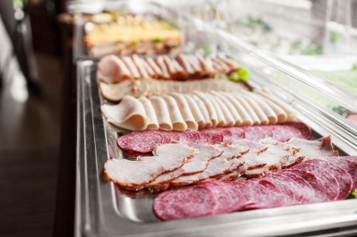 a row of different types of meat on a display case at Willa Kłodzko-Zacisze - sauna, siłownia, komnata solna, parking in Kłodzko