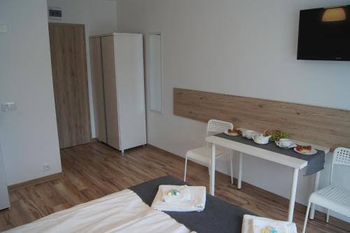 a small living room with a table and chairs at Willa Wena in Ustka