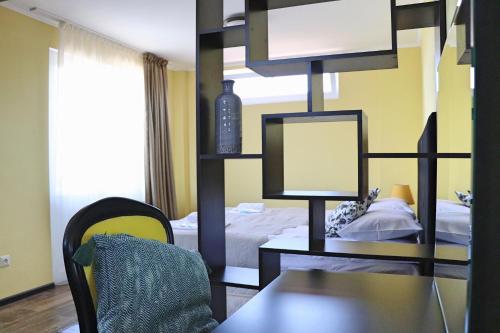 a room with a bed and a table and a desk at Penthouse Apartment 401 in Tbilisi City