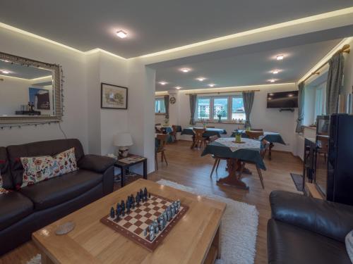 a living room with a chess board on a table at Landhaus Lilly in Obertraun