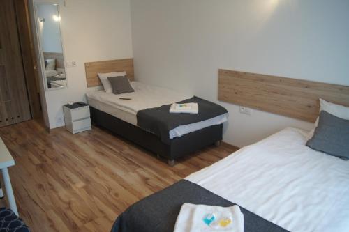a hotel room with two beds and a mirror at Willa Wena in Ustka