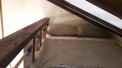 a bunk bed with two pillows on the stairs at Weekend House Petar in Lusnić