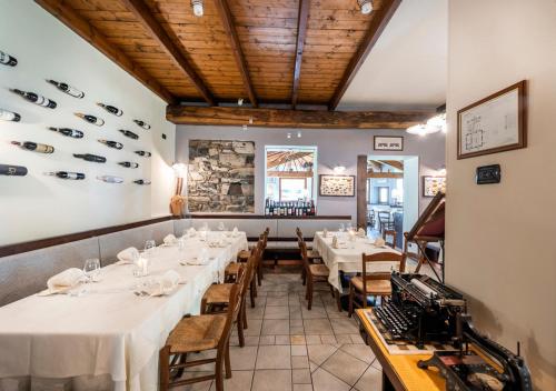 a dining room with white tables and chairs at Locanda Sant' Anna in Argegno