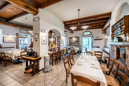 a restaurant with tables and chairs in a room at Locanda Sant' Anna in Argegno