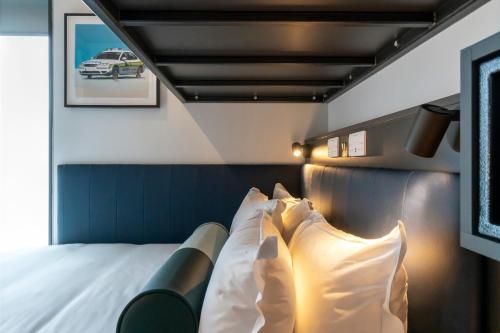 a bedroom with a bed with white pillows at The Hendrick Smithfield in Dublin