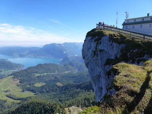 people standing on the edge of a mountain overlooking a lake at Landhaus Lilly in Obertraun