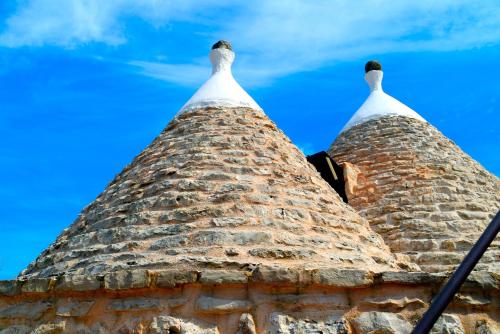 a view of the top of a brick tower with a blue sky at Dimore Storiche - Ulivo di Aldo in Martina Franca