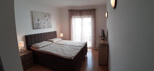 Postel nebo postele na pokoji v ubytování Apartmani Matušan