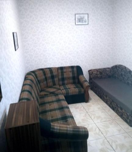 a living room with a couch and a chair at Parasolka in Luts'k