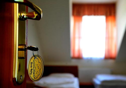 a room with a door with a tag on it at Hotel Złote Dęby in Warsaw