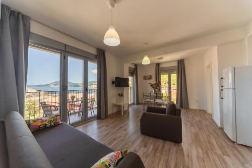 a living room with a couch and a refrigerator at Apartments My Przno in Sveti Stefan