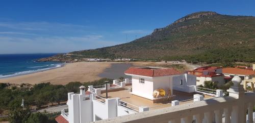 a house with a view of a beach at Villa Cap Spartel Tanger Achakkar FAMILY ONLY in Jebila
