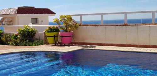 a swimming pool on the side of a building at Villa Cap Spartel Tanger Achakkar FAMILY ONLY in Jebila