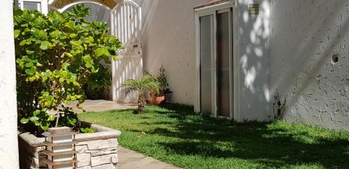 an entrance to a house with plants and a door at Villa Cap Spartel Tanger Achakkar FAMILY ONLY in Jebila