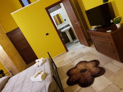 a bedroom with a bed with a teddy bear on it at La nassa fitta camere in Brindisi