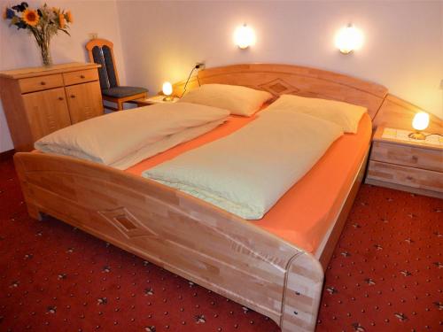 a large wooden bed in a room at La Pineta in Colfosco
